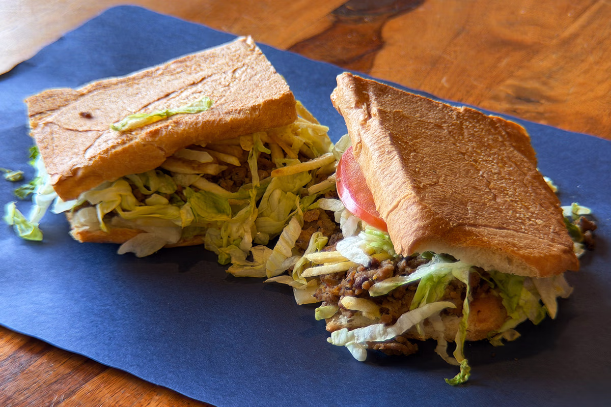 El Cubanito Steak sandwich with seasoned steak, lettuce, tomato, cheese, and shoestring potatoes in Chicago.